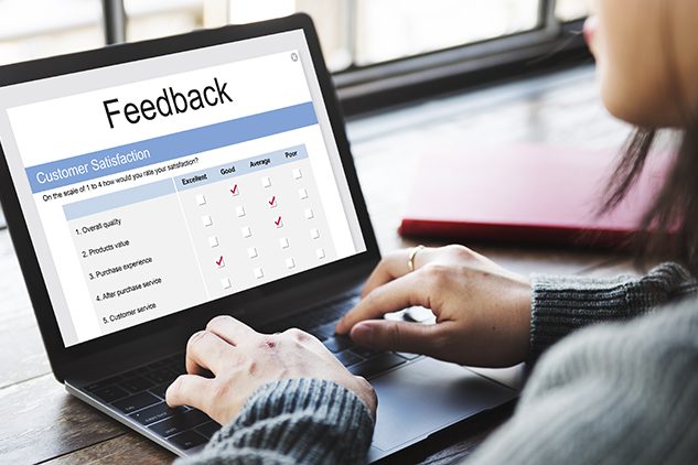 woman with laptop filling out feedback survey