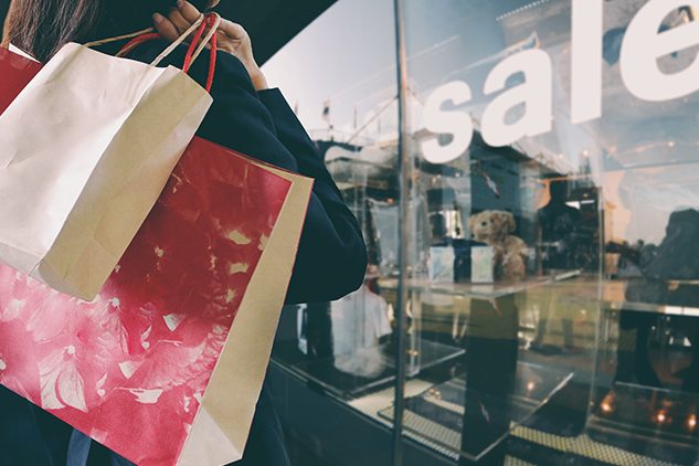 woman holding holiday shopping bags