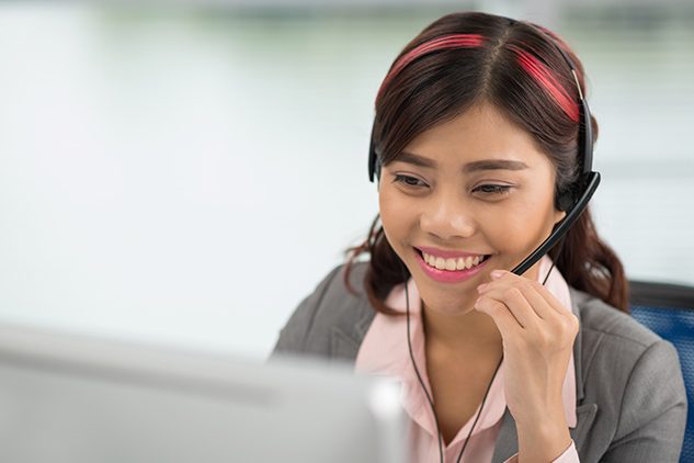 woman on headset at help desk