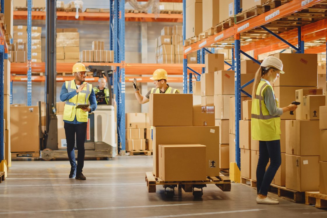 warehouse worker in warehouse moving packages