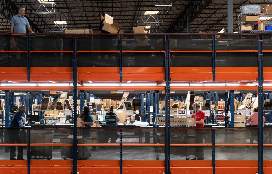 workers on the line in an ecommerce fulfillment center sorting packages