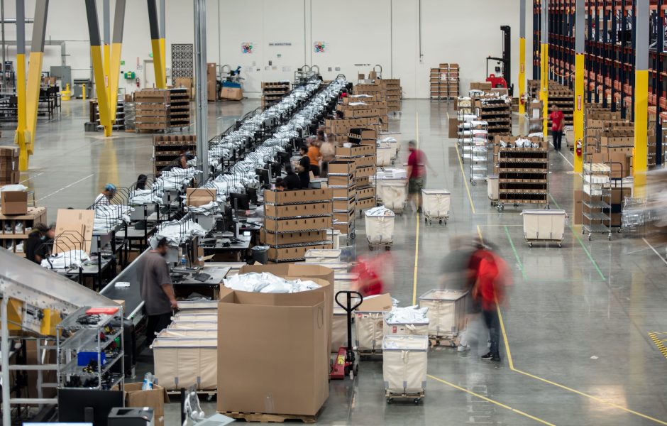 workers packing and shipping orders in an ecommerce fulfillment center
