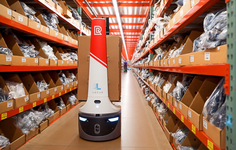 automated robot moving packages down the aisle in warehouse