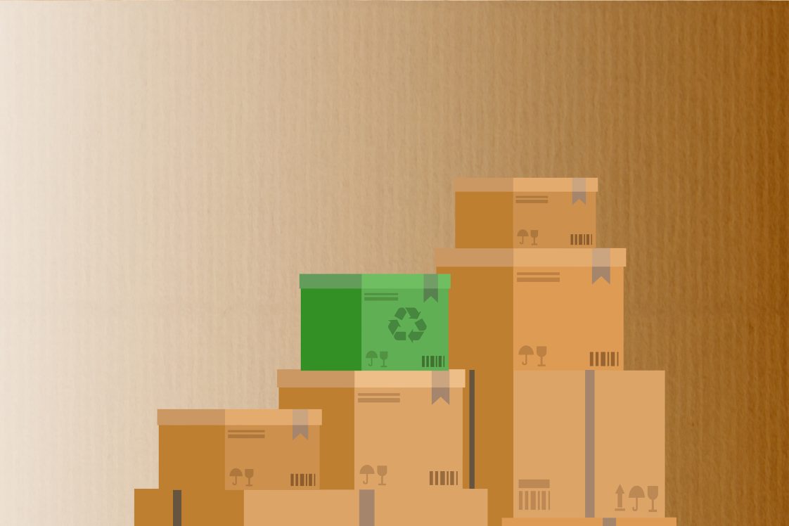 pile of cardboard boxes with a green recycled box on top