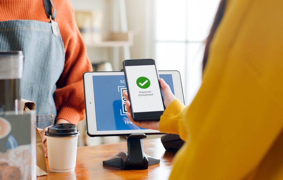 woman making a payment on phone in retail store