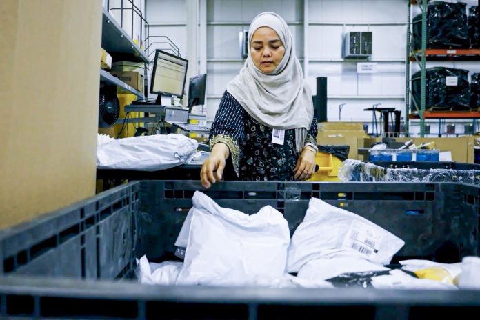 woman processing returns in a fulfillment center