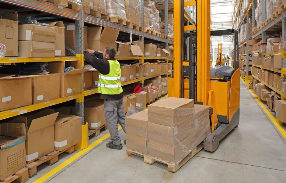 worker with forklift in fulfillment center