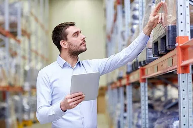 man working in warehouse with inventory