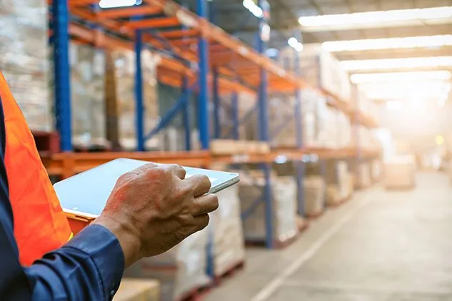 person in warehouse on ipad