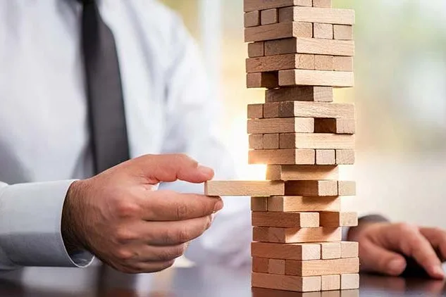 business man playing jenga