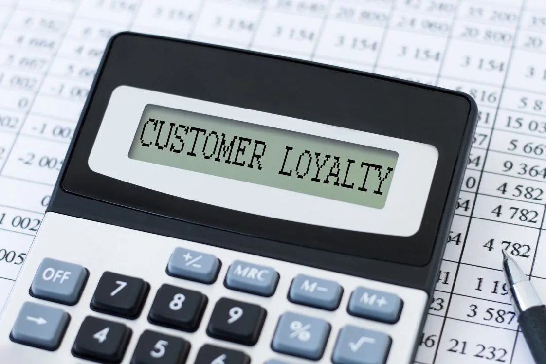 calculator with the words customer loyalty on the screen