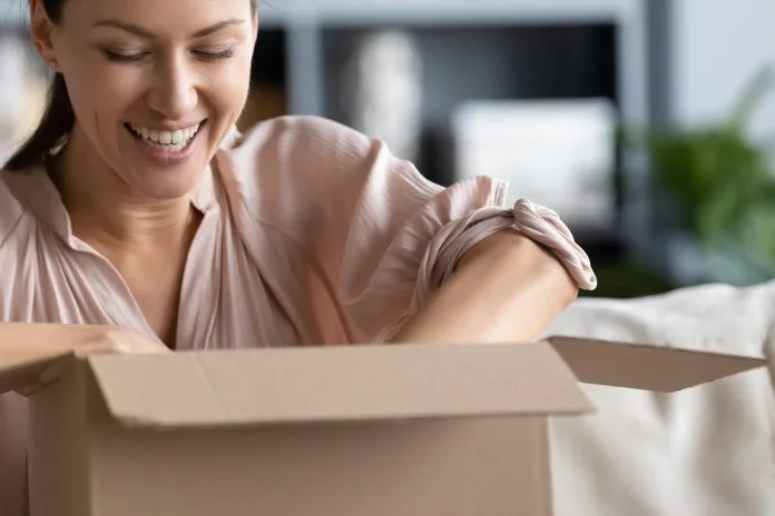 happy woman opening up a package