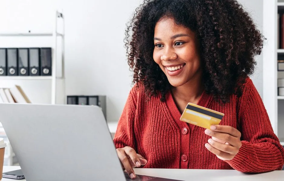 Woman smiling while paying for online order.