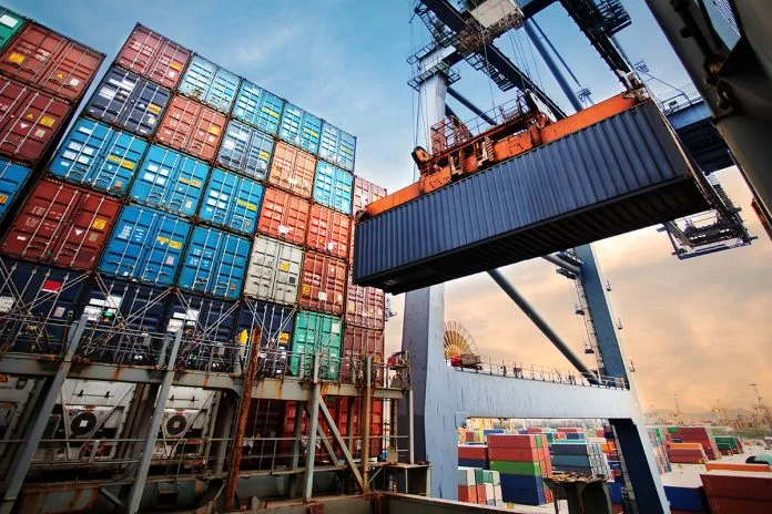 Container loading in a Cargo freight ship with industrial crane. Container ship in import and export business logistic company. Industry and Transportation concept.