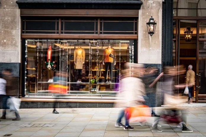 Motion blurred people on busy shopping street