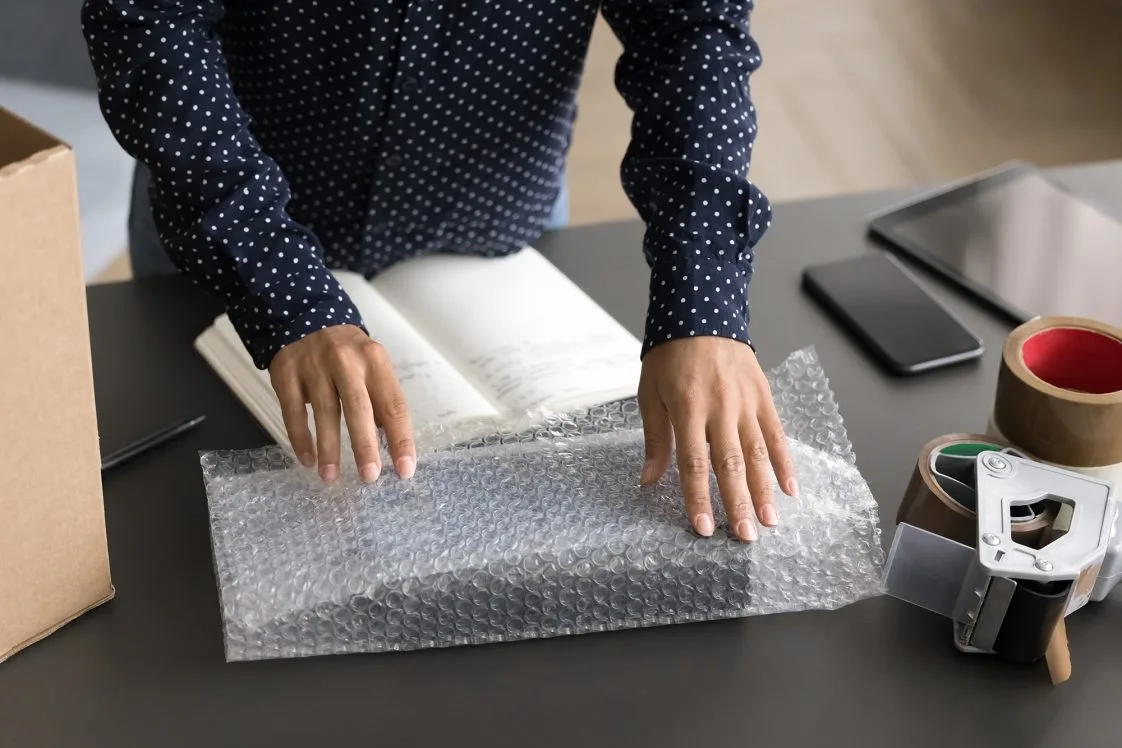 Close up of someone preparing a return parcel.